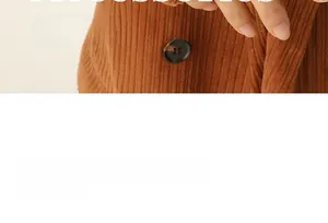 Macro shot of brown corduroy texture and amber-colored resin button on a vintage style garment