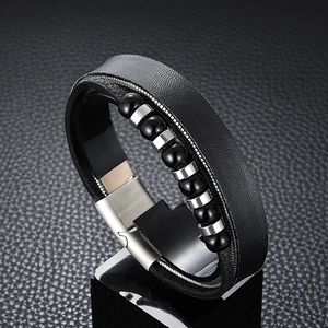 Men's multi-layer black leather bracelet with silver accents on a sleek black base