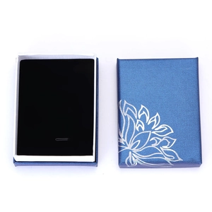 Blue jewelry gift box with silver lotus pattern and black velvet foam insert