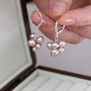 Detail of natural freshwater pearl grape cluster earrings with silver hooks