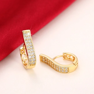 Macro view of gold-plated hoop earrings featuring multiple rows of inlaid white zircons