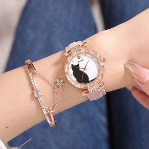 Close-up of elegant rose gold cat pattern watch with pink leather strap and star bracelet