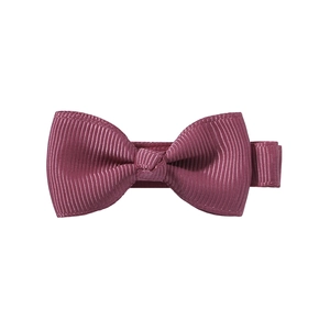 Detailed view of a multi-layered dark red grosgrain ribbon bow clip with fine texture