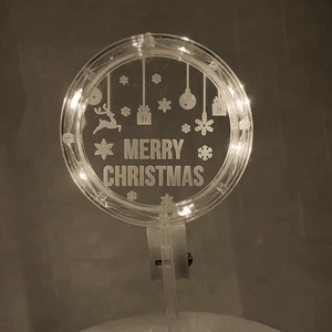 Macro detail of glowing LED Merry Christmas acrylic cake topper with reindeer design