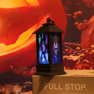 Close-up of Halloween lantern with ghost pattern and glowing warm pumpkin background