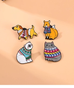 Set of four cartoon animal enamel pins featuring a dog, fox, polar bear, and cat in sweaters