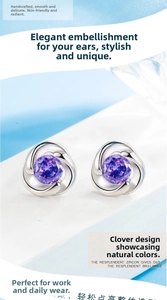 Macro shot of clover-shaped silver stud earrings featuring round-cut purple zircon stones