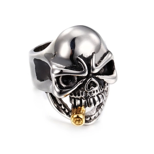Detail of punk skull ring with golden pipe accent and polished silver finish
