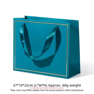 Luxurious teal gift bag with gold trim and satin handles, dimensions 27x10x22cm