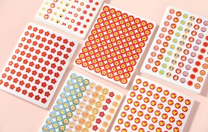 Close-up of assorted colorful reward stickers featuring stars, flowers, and pandas