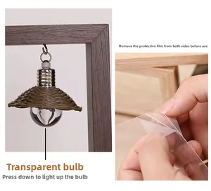 Detail of wooden pet frame with a press-to-light bulb and protective film removal