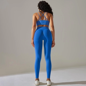 Detail of blue seamless ribbed yoga set featuring a cross back bra and high waist leggings