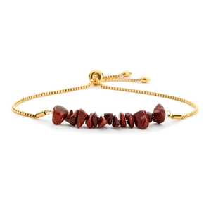 Detail view of gold adjustable chain bracelet with irregular red crystal stone beads