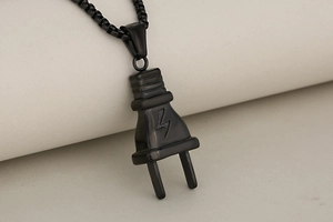 Detail of black stainless steel power plug pendant with lightning bolt logo and box chain