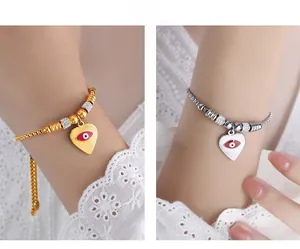 Detail of heart evil eye bracelets in gold and silver with sparkling rhinestones