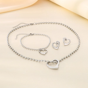 Detailed view of silver stainless steel jewelry set with hollow heart pendants and bead chain