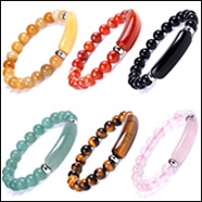 Detail showing six varieties of 8mm natural stone yoga bracelets with metal spacers