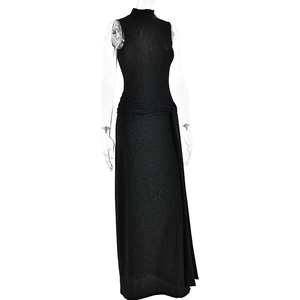 Close-up of sleeveless black evening gown with shimmering fabric and waist pleats