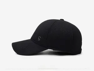 Close-up of side view of a black winter baseball cap with metal C logo and thick wool texture