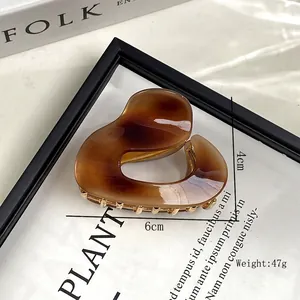 Elegant amber acetate heart-shaped hair claw clip with golden metal teeth for women