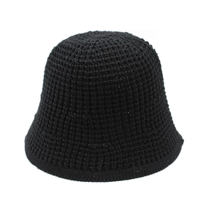Close-up of black crochet knit bucket hat showing detailed mesh weave texture