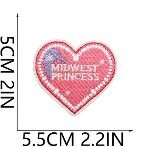 Macro detail of heart-shaped Midwest Princess embroidered patch with pink fuzzy texture