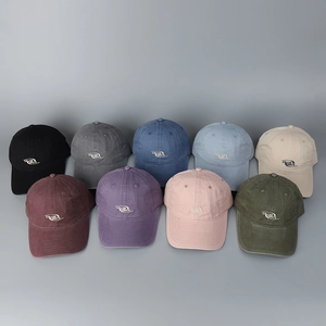 Flat lay of multiple color cotton baseball caps featuring white collaborate embroidery