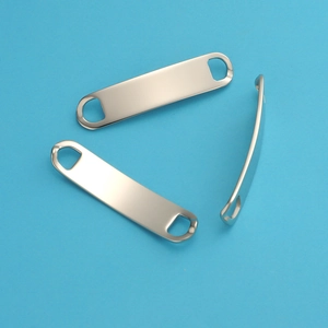 Close-up of three polished silver stainless steel curved rectangle connectors for DIY jewelry