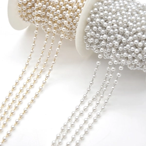 Elegant gold and silver pearl bead chains on white spools for DIY jewelry making