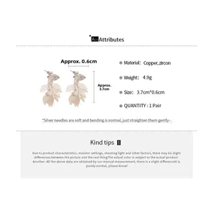 Detail view of layered leaf tassel earrings with sparkling zircon and silver needles