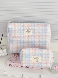 Set of quilted checkered makeup bags with heart patterns in soft pink and blue tones