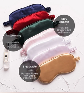 Multiple colors of silk sleep masks arranged on stone background showing smooth texture