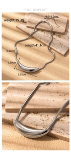 Detail view of silver snake chain necklace with curved tube pendant and size measurements