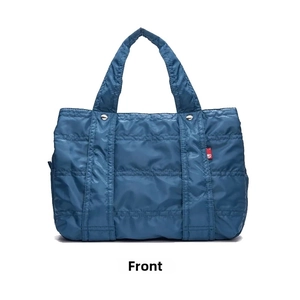 Front view of a blue quilted nylon puffer tote bag with handles and metal rivet details