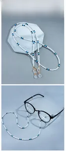 Detailed view of pearl beaded eyewear chain with blue accents and silicone loop