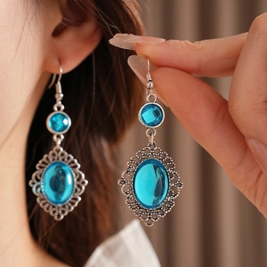 Vintage bohemian oval blue resin earrings with ornate silver-tone floral lace edges