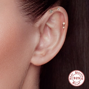 Minimalist S925 sterling silver arrow and dot cartilage stud earrings worn by model