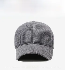 Detail view of dark grey winter baseball cap featuring warm textured fabric and metal logo