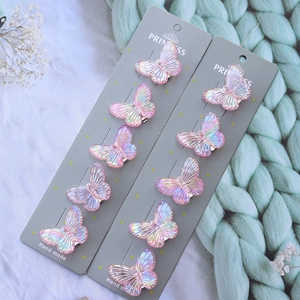 Detail shot of a 10-piece set of colorful gradient resin butterfly hair clips on a card