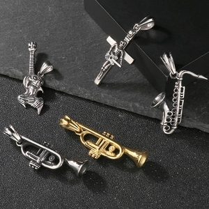 Detailed close-up of saxophone, trumpet, and skull guitar pendants in retro hip hop style