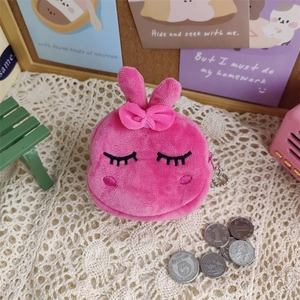 Close-up of pink plush bunny coin purse with cute embroidered eyes and a bow