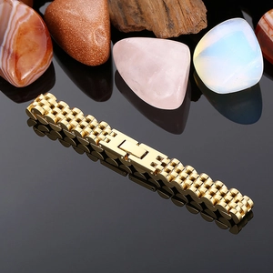 Detailed shot of a gold stainless steel watch strap on a black reflective surface with gems
