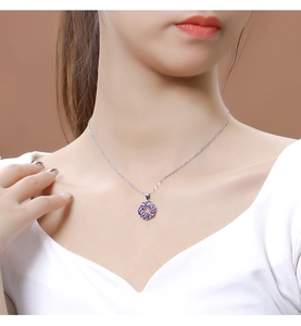 Close-up of elegant 925 sterling silver necklace with purple zircon pendant worn on neck