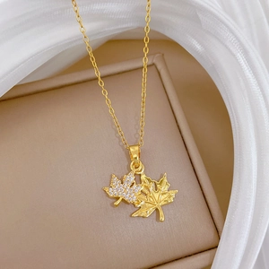 Close-up of double maple leaf pendant with pavé crystals and gold plated O-chain