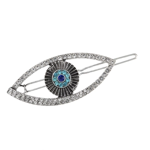 Silver metal evil eye hair clip with turquoise rhinestones on white background