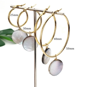 Minimalist gold hoop earrings in 25mm to 50mm sizes with natural mother of pearl charms