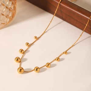 Golden stainless steel necklace with graduated gold beads on a delicate snake chain