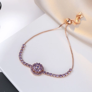 Detail of rotating purple zircon flower bracelet with rose gold adjustable slider clasp