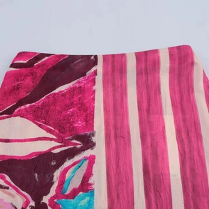 Women's silk-textured midi skirt with pink floral pattern and vertical stripes