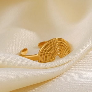 Golden geometric rainbow open ring in stainless steel for women on beige silk background